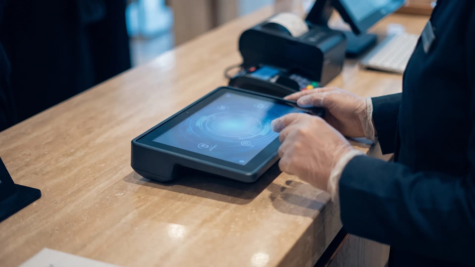 A retail staff member issuing a ZATCA-compliant digital invoice on a tablet point-of-sale terminal