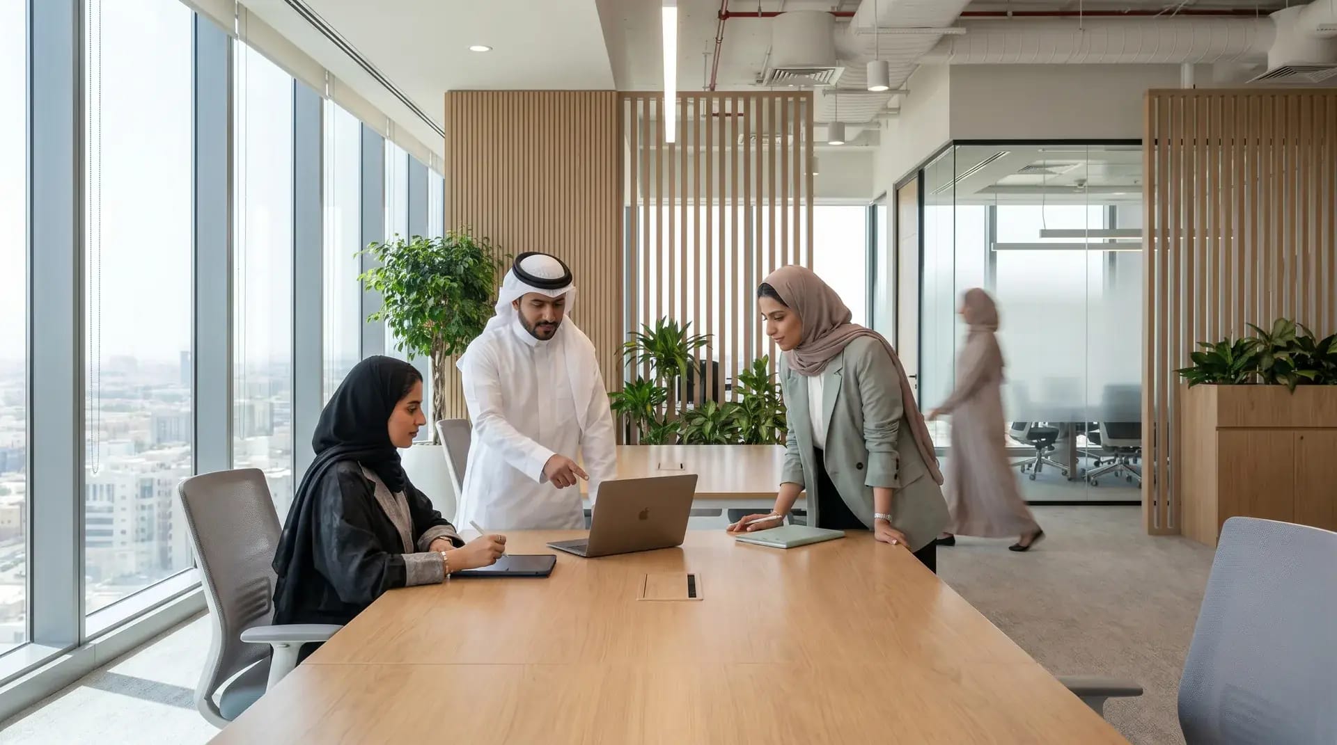A Saudi SME team collaborating in a modern Riyadh office, illustrating how weighted Saudisation counting changes the economics of Saudi hiring