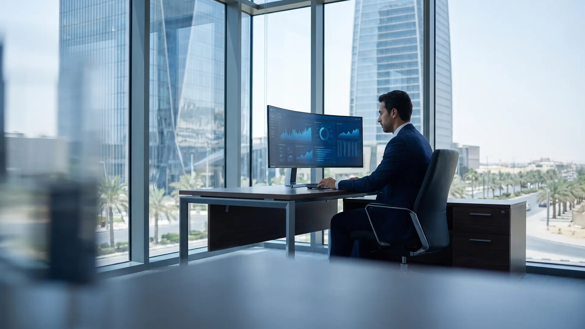 A finance manager reviewing a cloud accounting dashboard in a modern Riyadh office